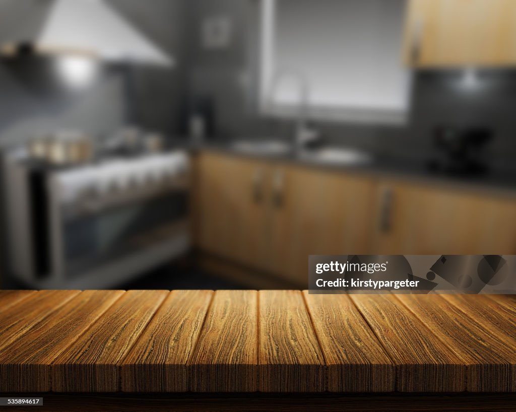 Wooden table with kitchen in background