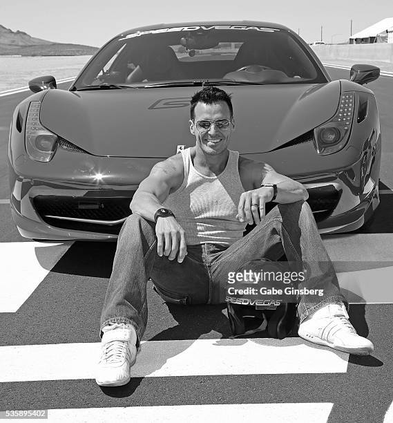 Actor/model Antonio Sabato Jr. Poses with a 2013 Ferrari 458 Italia at the SpeedVegas motorsports complex on May 30, 2016 in Las Vegas, Nevada.