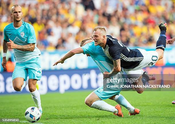 Sweden's forward John Guidetti vies with Slovenia's defender Nejc Skubic during the friendly football match between Sweden and Slovenia at Swedbank...