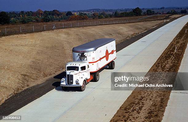 View of a truck driver, drives a Mack Truck down the interstate for Cooper Jarrett Motor Freight Lines in Illinois.