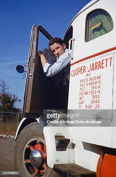 View of a truck driver, as he drives a Mack Truck for Cooper Jarrett Motor Freight Lines in Illinois.