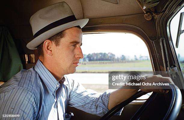View of a truck driver, as he drives a Mack Truck for Cooper Jarrett Motor Freight Lines in Illinois.