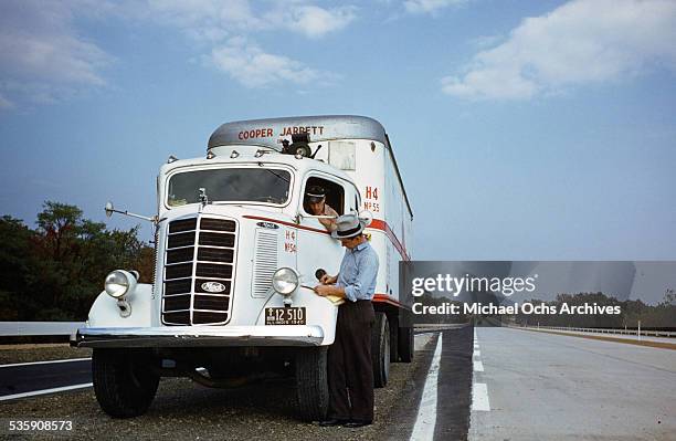 View of a truck driver, as he drives a Mack Truck for Cooper Jarrett Motor Freight Lines in Illinois.