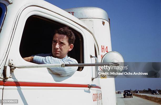 View of a truck driver, as he drives a Mack Truck for Cooper Jarrett Motor Freight Lines in Illinois.