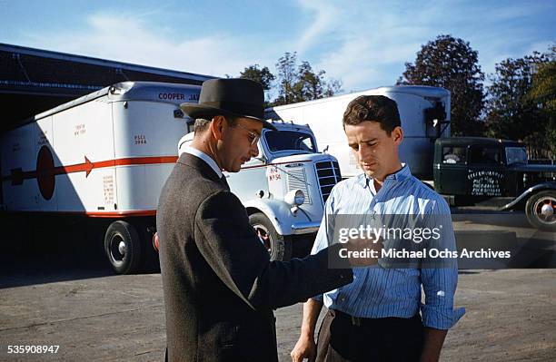 View of a truck driver, gets his work orders, as he drives a Mack Truck for Cooper Jarrett Motor Freight Lines in Illinois.