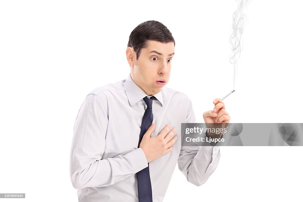 Man smoking a cigarette and feeling chest pain