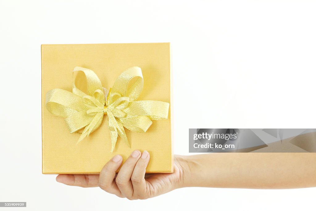 Woman holding a gold gift box