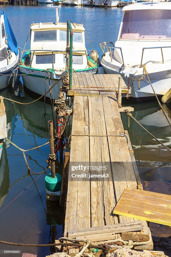 Small fishing boats on the old pier