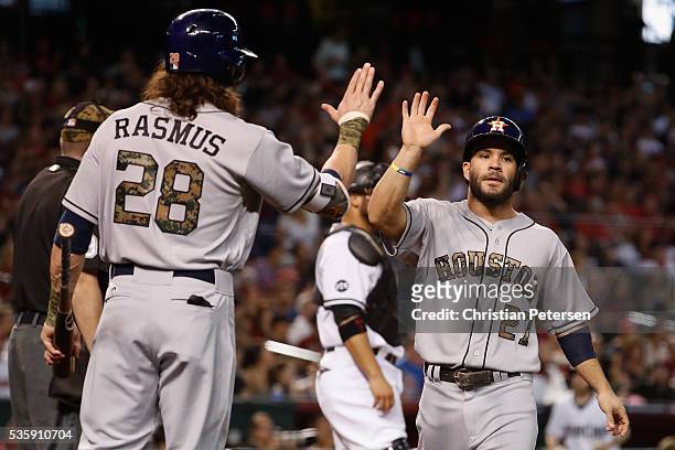 Jose Altuve of the Houston Astros high-fives Colby Rasmus after scoring a run against the Arizona Diamondbacks during the fourth inning of the MLB...