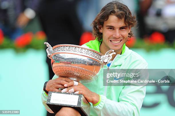 Rafael Nadal of Spain celebrates with the trophy after winning the men's singles final match between Rafael Nadal of Spain and Robin Soderling of...