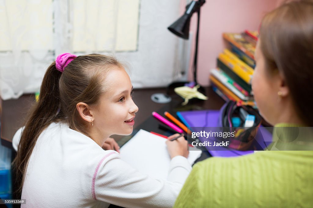 Mother with daughter doing homework