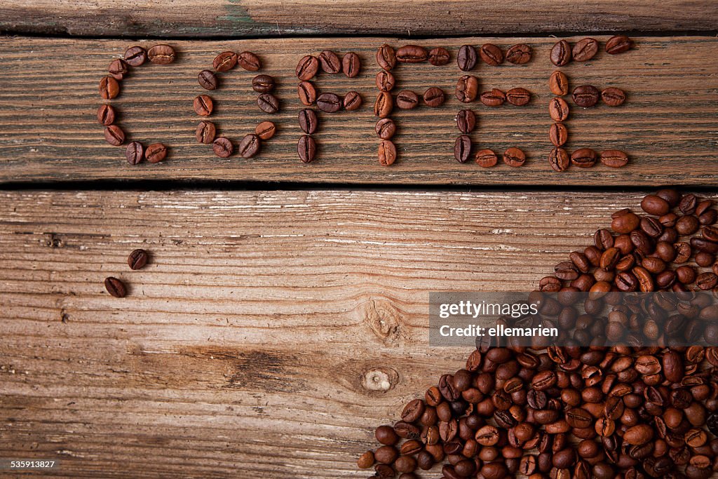 Coffee beans on wooden background