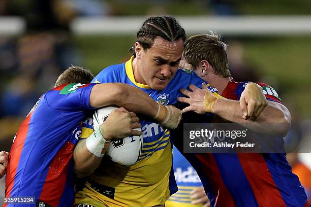 Brad Takairangi of the Eels is tackled by the Knights defence during the round 12 NRL match between the Newcastle Knights and the Parramatta Eels at...