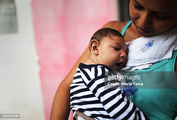 Mother Daniele Santos holds her baby Juan Pedro, who has microcephaly, on May 30, 2016 in Recife, Brazil. Microcephaly is a birth defect linked to...