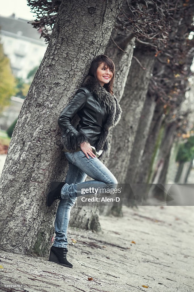 Pretty young woman posing outdoors