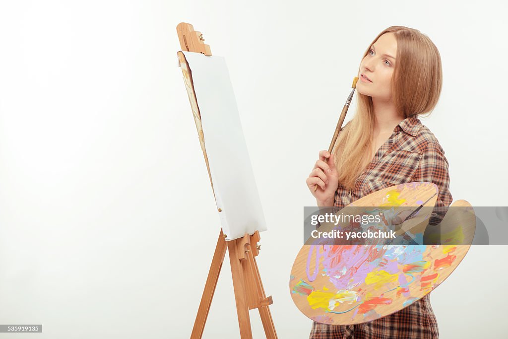Young beautiful artist creating a masterpiece