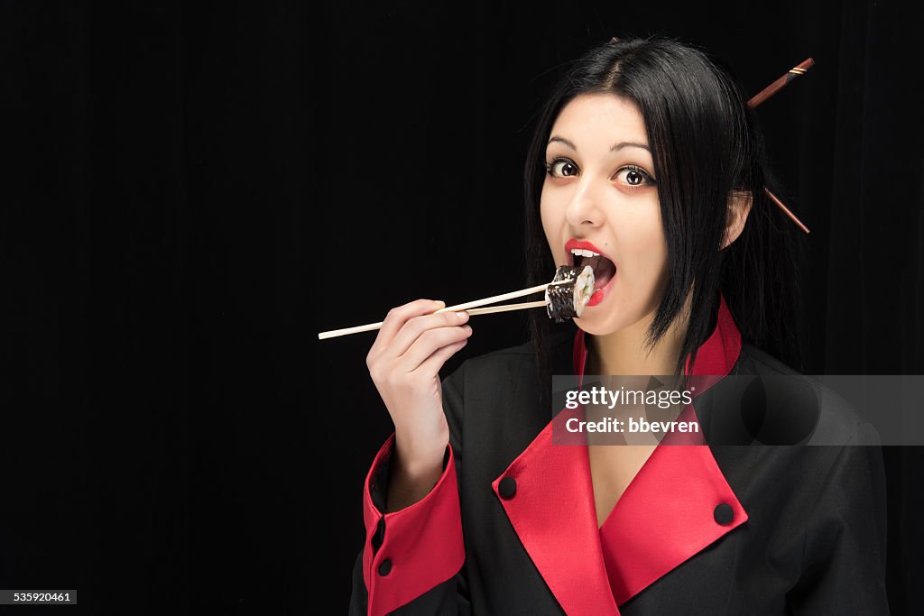 Young and attractive asian make-up chef girl tasting sushi with