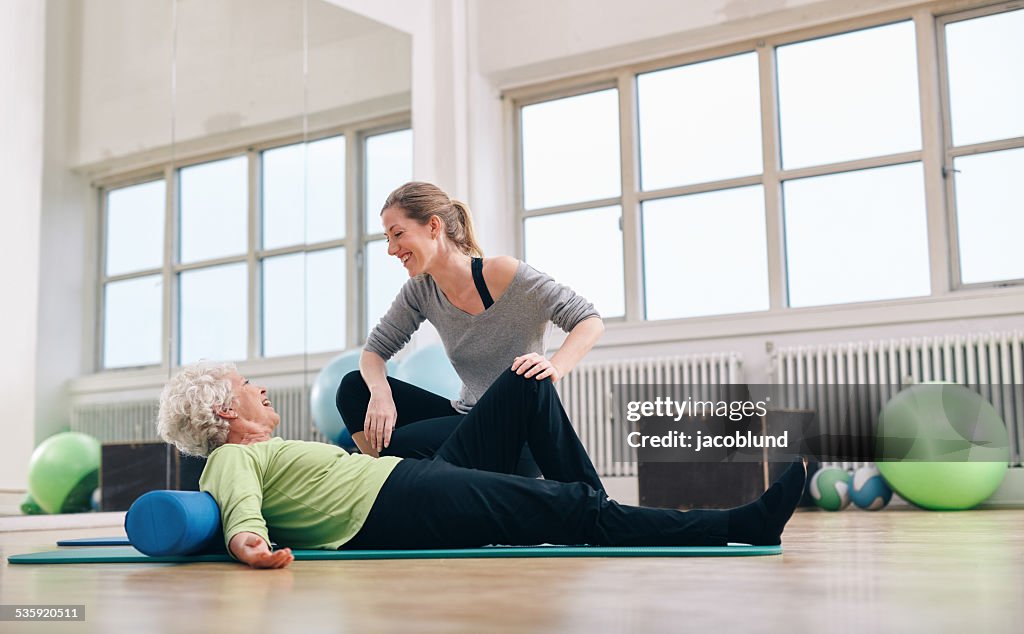 Senior woman having a friendly chat with her personal trainer