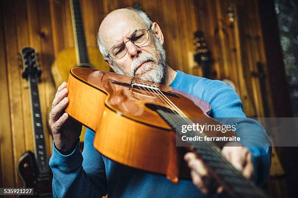 luthier guitarra examinar una clásica en el taller - instrument maker fotografías e imágenes de stock