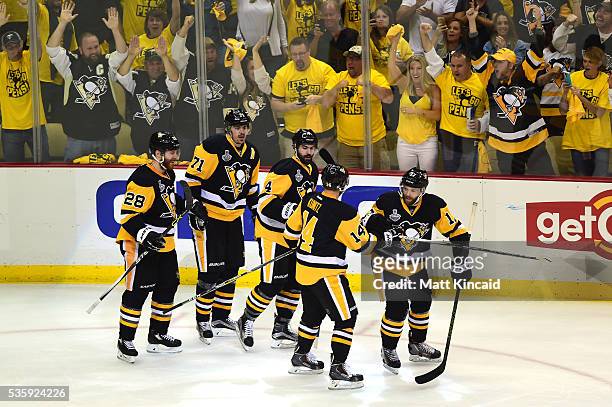 Bryan Rust of the Pittsburgh Penguins celebrates with Chris Kunitz, Justin Schultz, Evgeni Malkin, and Ian Cole after scoring a first period goal...