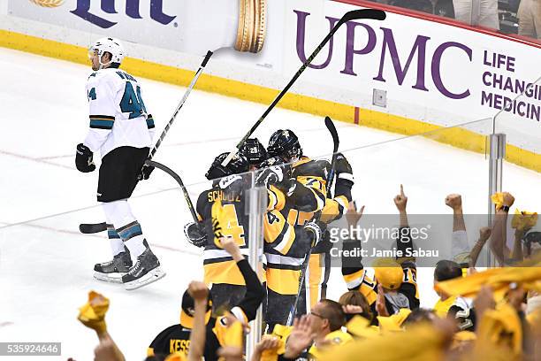 Bryan Rust of the Pittsburgh Penguins celebrates with Justin Schultz, Evgeni Malkin, and Ian Cole after scoring a first period goal against the San...