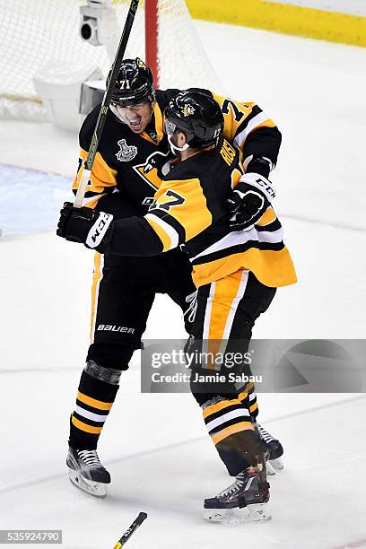 Bryan Rust of the Pittsburgh Penguins celebrates with Evgeni Malkin after scoring a first period goal against Martin Jones of the San Jose Sharks in...