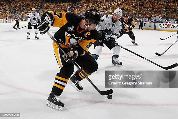 Sidney Crosby of the Pittsburgh Penguins moves the puck in front of Nick Spaling of the San Jose Sharks during Game One of the 2016 NHL Stanley Cup...