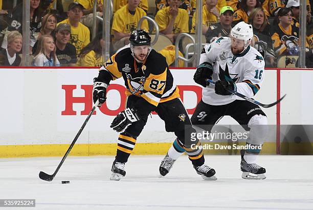 Sidney Crosby of the Pittsburgh Penguins protects the puck from Nick Spaling of the San Jose Sharks during the first period of Game One of the 2016...
