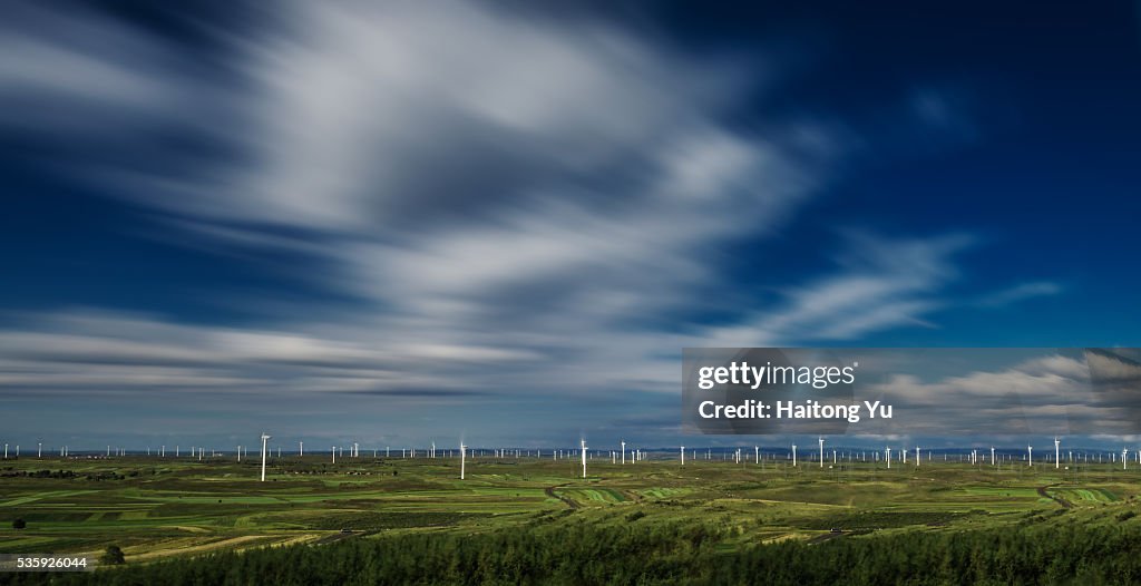 Flying clouds above wind farm