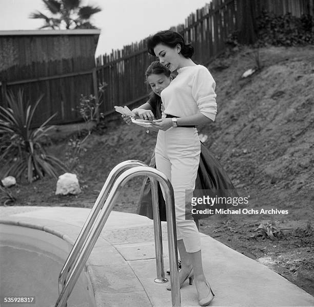 Actress Natalie Wood poses by her swimming pool with her sister Lana at her home in Los Angeles,CA.