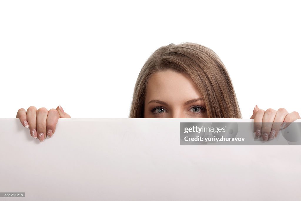 Woman looking over blank card in the studio