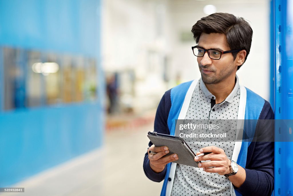 Businessman using digital tablet in warehouse