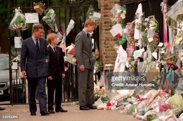 The Prince of Wales, Prince William and Prince Harry look at floral tributes to Diana, Princess of Wales outside Kensington Palace on September 5,...