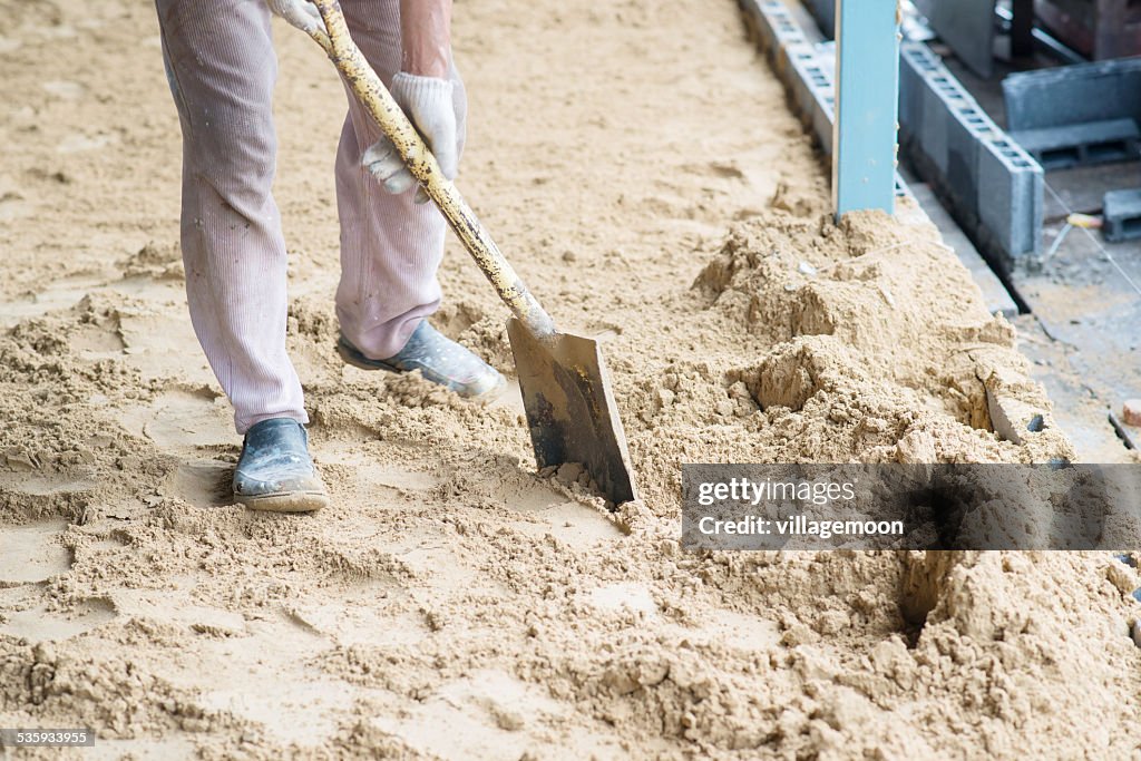 Man digging in the ground with shovel and spade