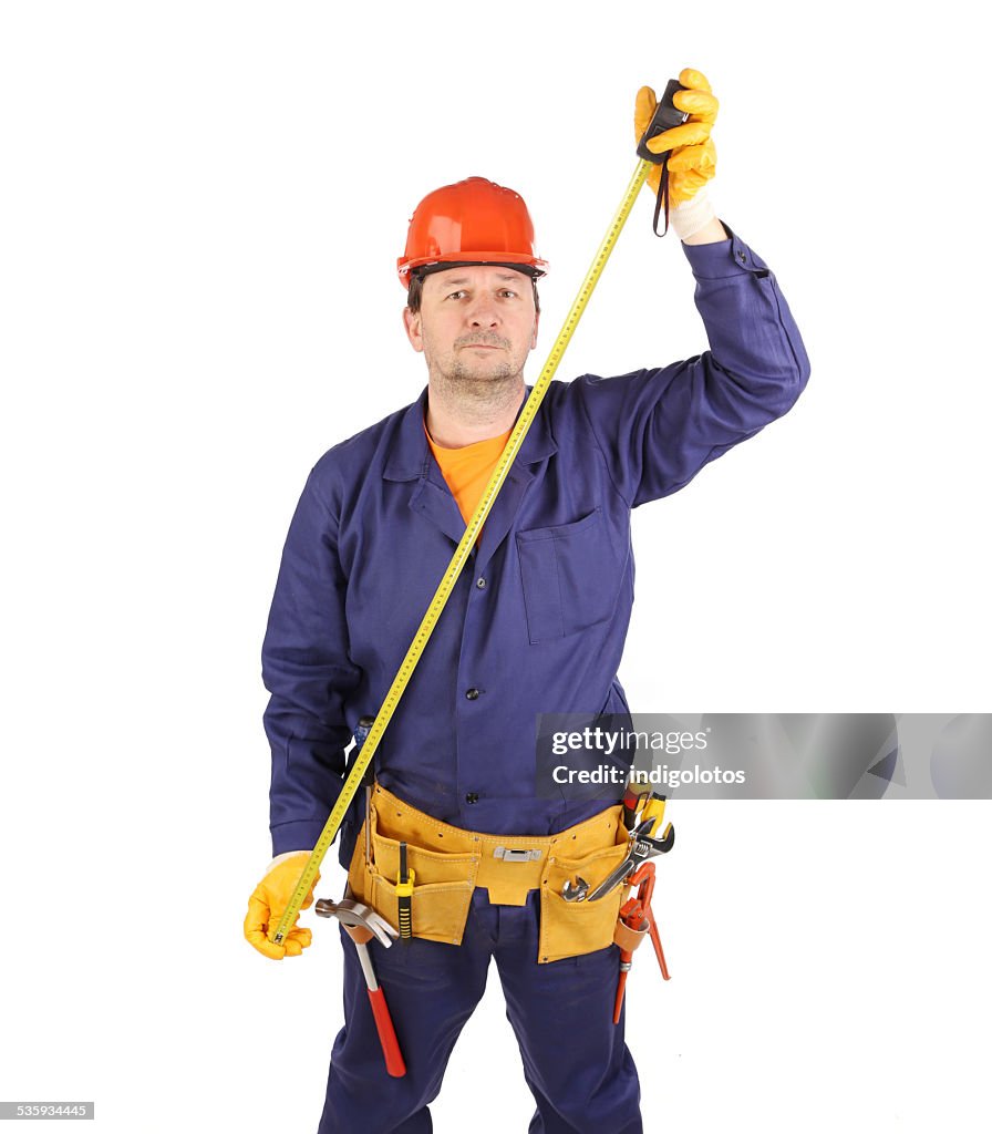 Worker in hard hat with ruler.