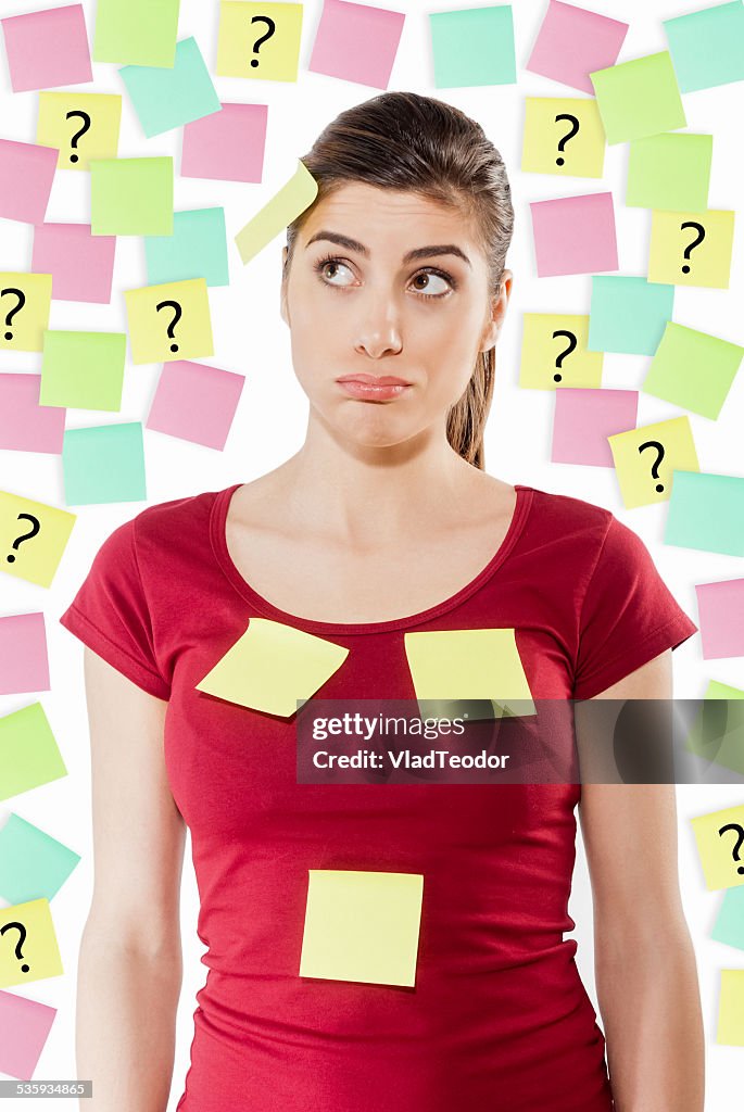Busy woman against wall covered with colorful stickers
