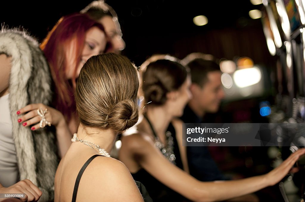 Young people playing slot machines at the Casino