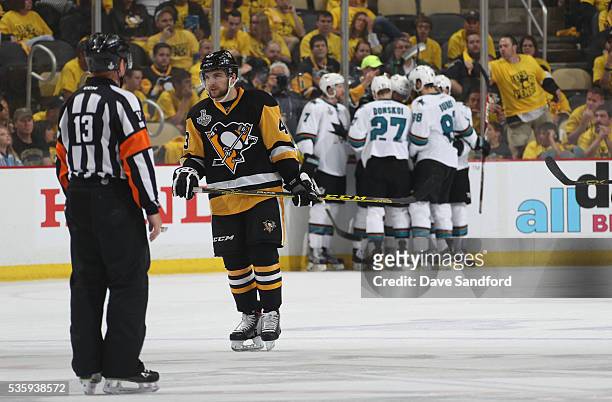 Conor Sheary of the Pittsburgh Penguins looks on as Paul Martin, Joonas Donskoi, Logan Couture, Brent Burns and Joel Ward of the San Jose Sharks...
