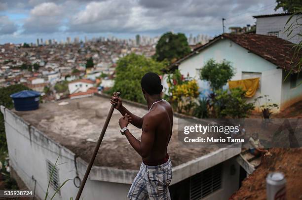 Man pauses while working in the Casa Amarela neighborhood on May 29, 2016 in Recife, Brazil. The city of Recife and surrounding Pernambuco state...