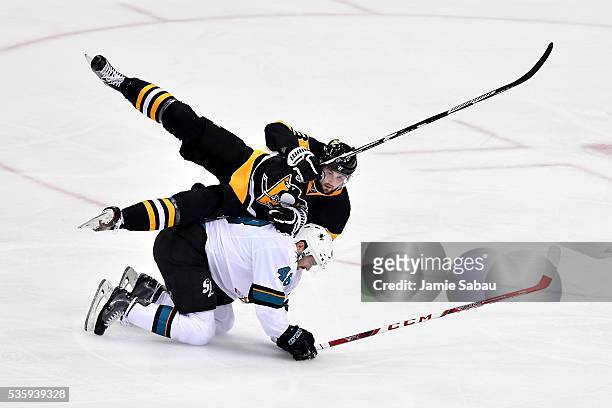 Brian Dumoulin of the Pittsburgh Penguins and Tomas Hertl of the San Jose Sharks fall on the ice during the second period in Game One of the 2016 NHL...