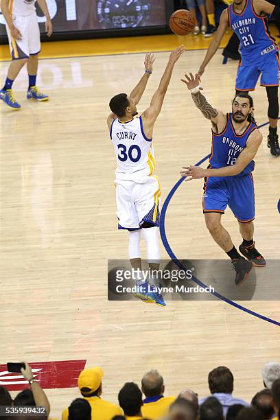 Stephen Curry of the Golden State Warriors shoots against Steven Adams of the Oklahoma City Thunder in Game Seven of the Western Conference Finals...