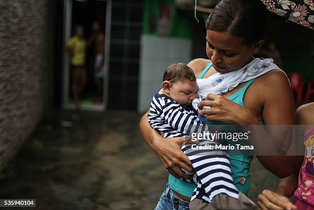 Mother Daniele Santos walks with her baby Juan Pedro, who has microcephaly, on May 30, 2016 in Recife, Brazil. Microcephaly is a birth defect linked...