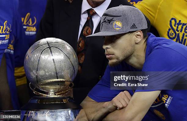 Stephen Curry of the Golden State Warriors poses with the Western Conference Trophy they beat the Oklahoma City Thunder in Game Seven of the Western...