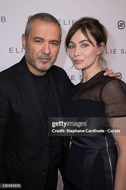 Elie Saab and Emmanuelle Beart pose backstage after Elie Saab show as part of the Paris Fashion Week Womenswear Fall/Winter 2014-2015, in Paris.