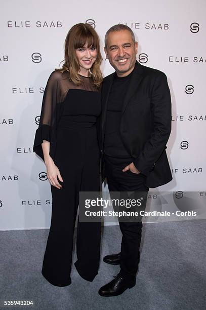 Elie Saab and Marie-Josee Croze pose backstage after Elie Saab show as part of the Paris Fashion Week Womenswear Fall/Winter 2014-2015, in Paris.
