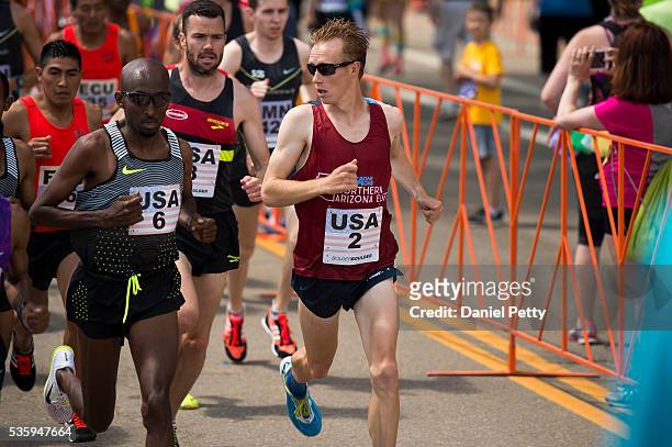 Scott Fauble of the United States looks over to Abdi Abdirahman of the United States during the men's elite competition during the Bolder Boulder 10K...
