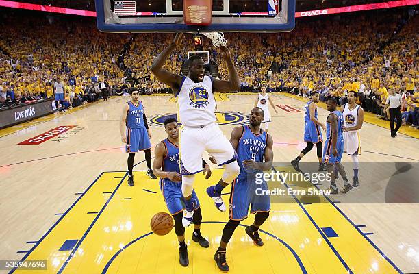 Draymond Green of the Golden State Warriors dunks the ball on Russell Westbrook and Serge Ibaka of the Oklahoma City Thunder in Game Seven of the...