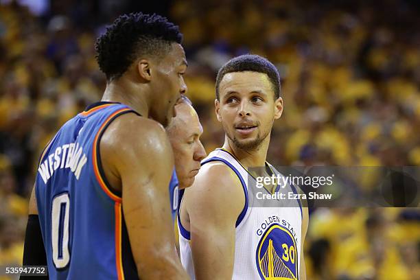 Stephen Curry of the Golden State Warriors and Russell Westbrook of the Oklahoma City Thunder stand on the court in Game Seven of the Western...