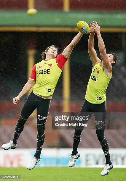 Kurt Tippett of the Swans competes against Callum Sinclair of the Swans during a Sydney Swans AFL training session at Sydney Cricket Ground on May...