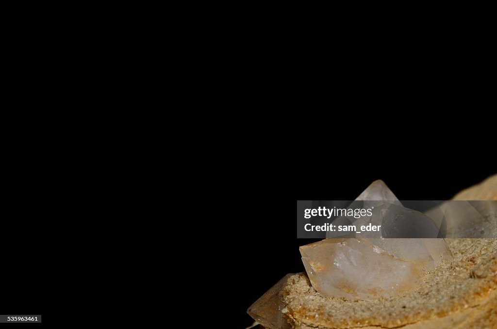 Rock crystal on stone and black